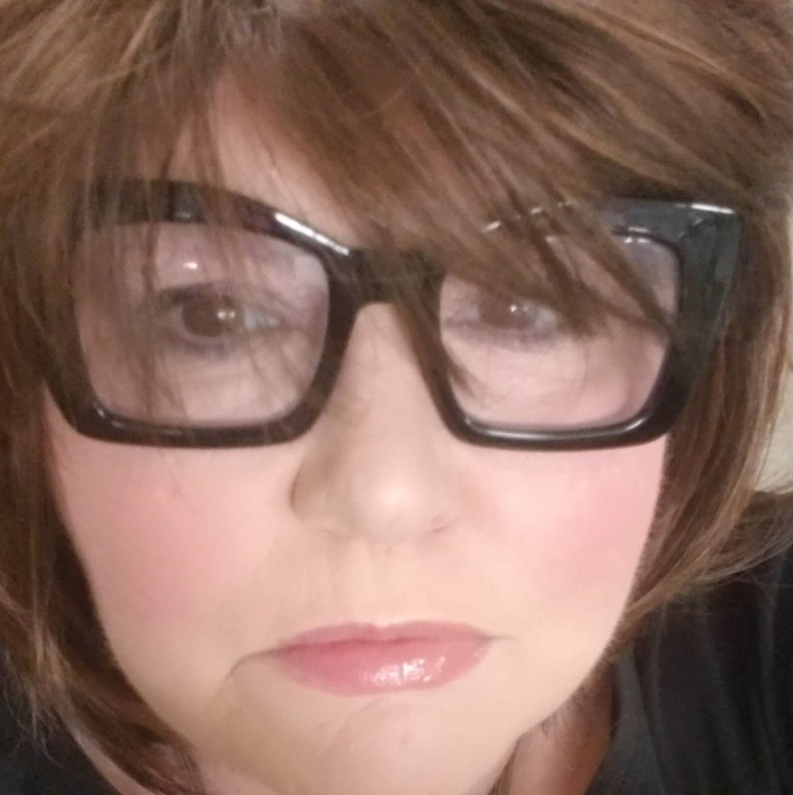 Linda smiling in her craft room